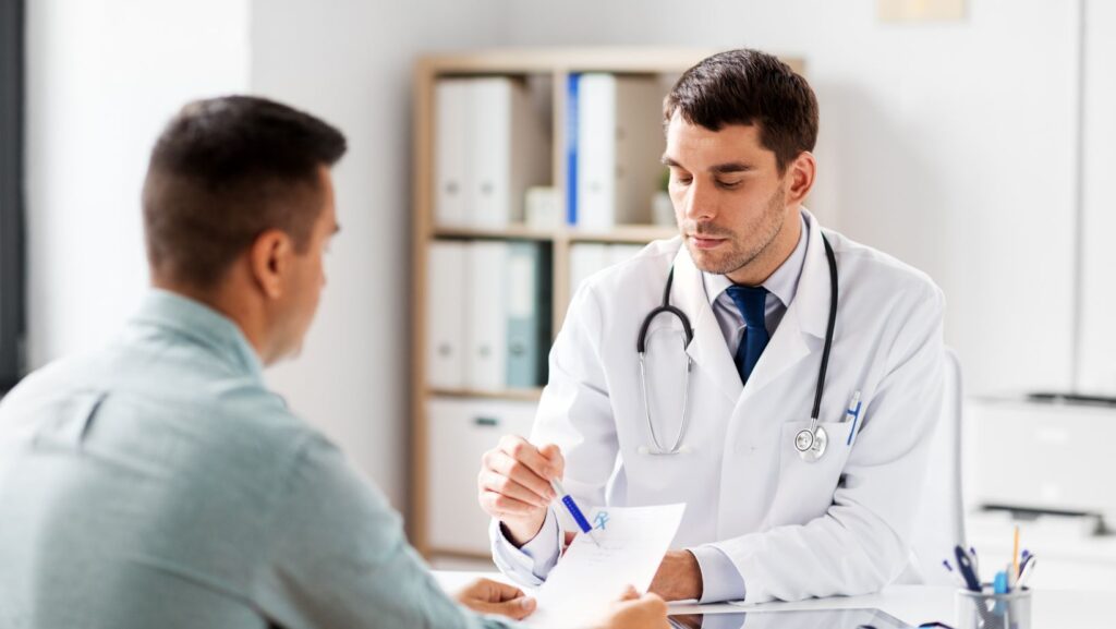 Doctor in a white coat showing a patient some information