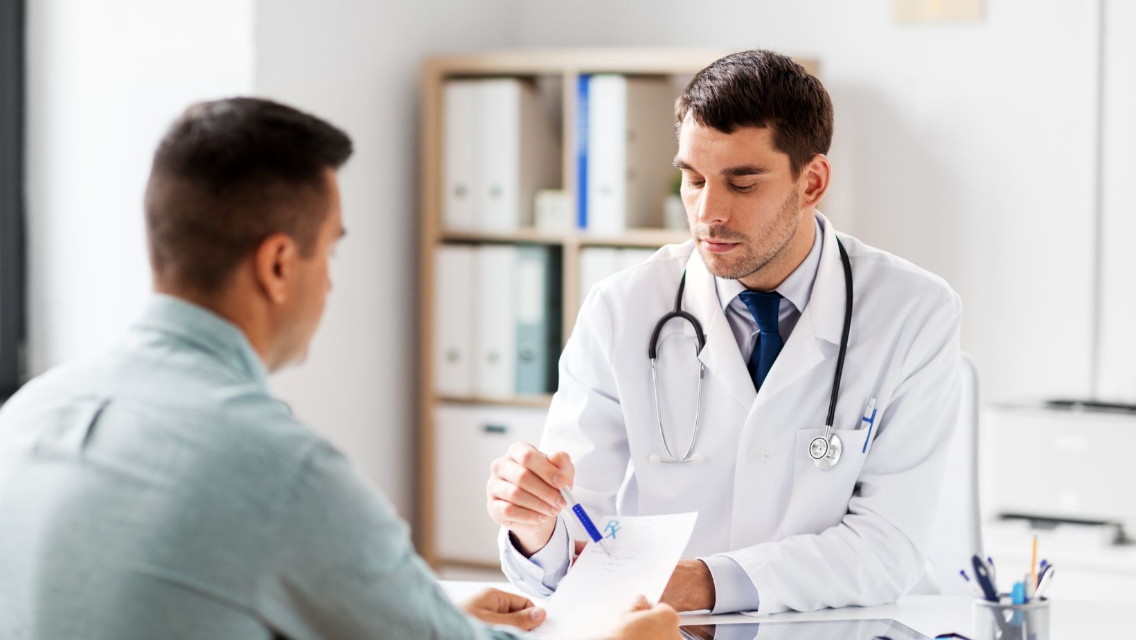 Doctor in a white coat showing a patient some information