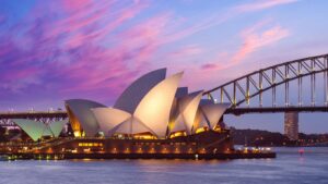 Sydney Opera House & Harbour against a pink sky